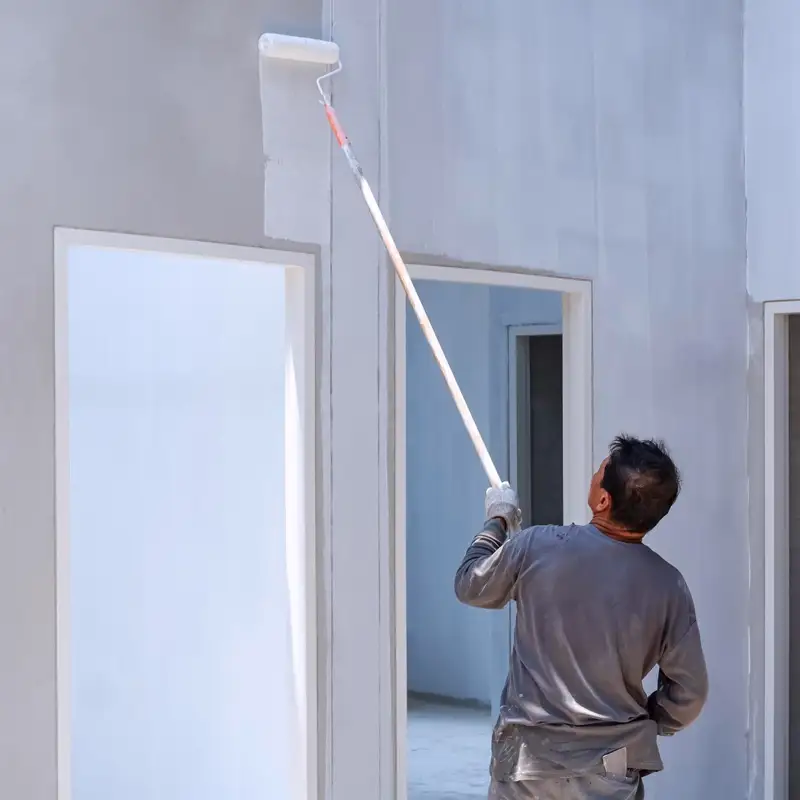 Application de peinture sur un mur intérieur par un professionnel